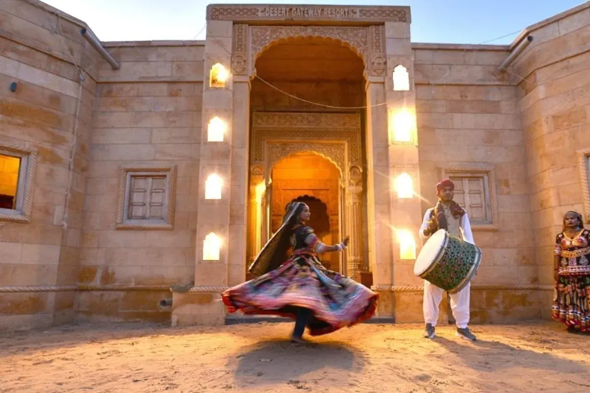 Rajasthani folk dancer performing in a sandstone courtyard