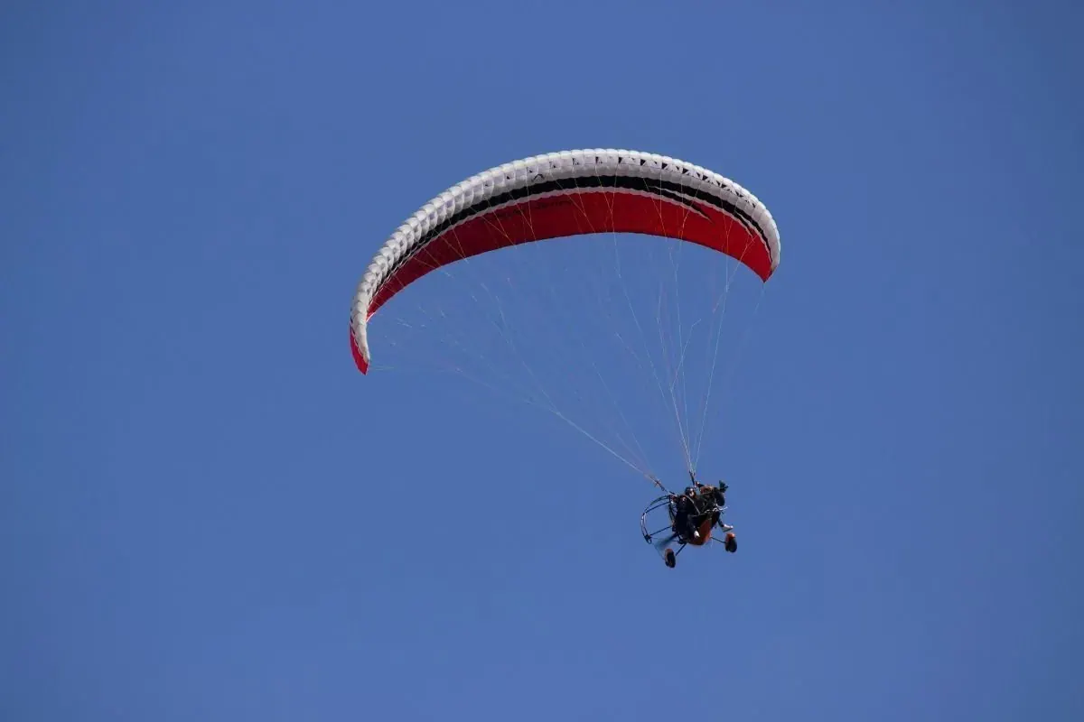 Paraglider soaring above the Sam Sand Dunes