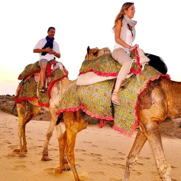Tourists on a camel safari at Sam Sand Dunes